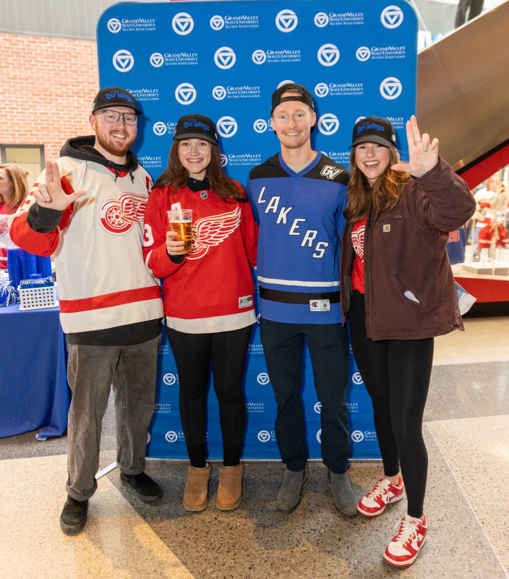 Four Lakers standing together for a picture at the Red Wings game.